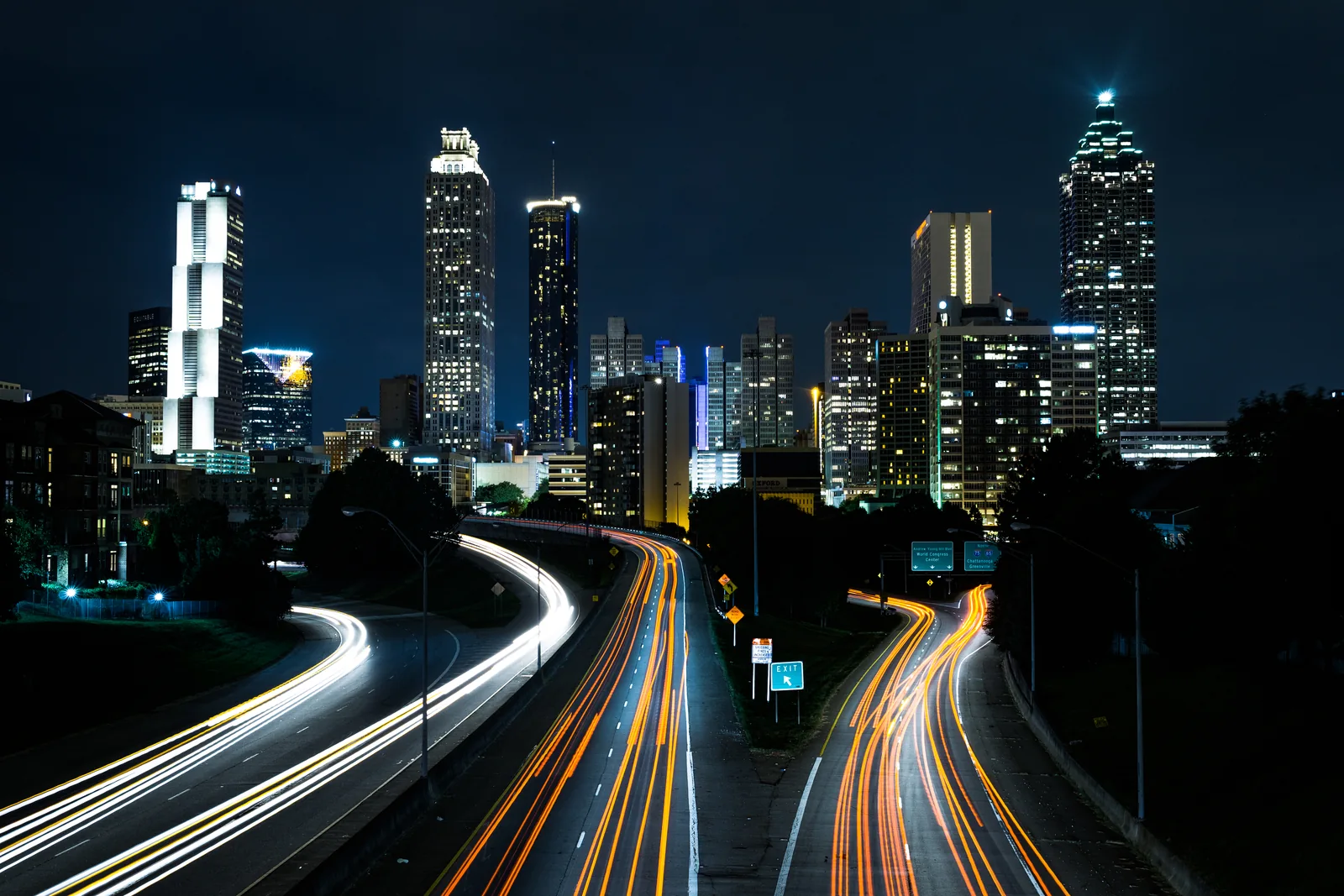 Atlanta’s illuminated downtown skyline from Jackson Street Bridge at night.