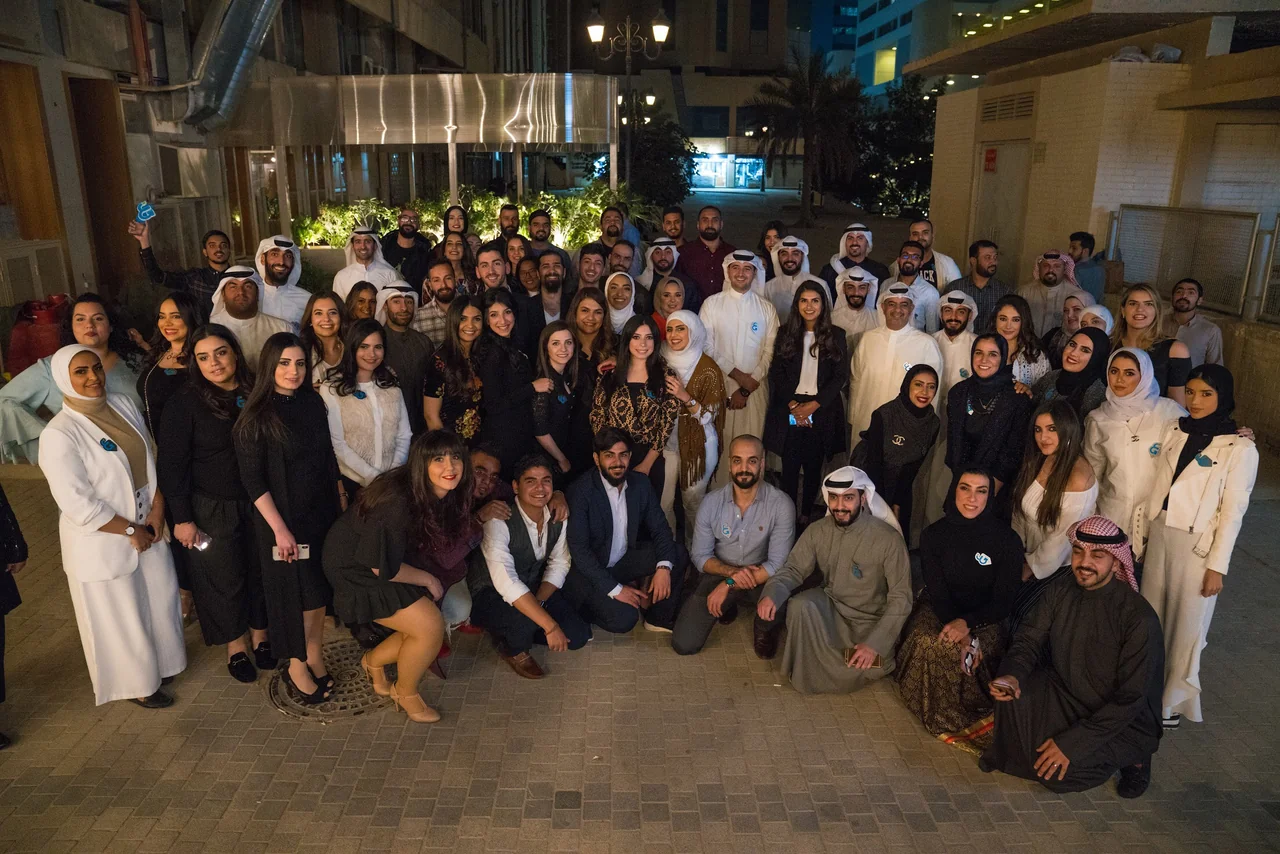 A large group posing together at an outdoor evening gathering.